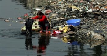 เมืองกุ้ยอวี๋ที่กำลังจะตายอันเนื่องจากเป็นศูนย์กลางการรีไซเคิลขยะพิษปริมาณมหาศาล ที่มาภาพ : http://www.greenpeace.org/eastasia/Global/eastasia/photos/toxics/ewaste/guiyu-woman-river.jpg