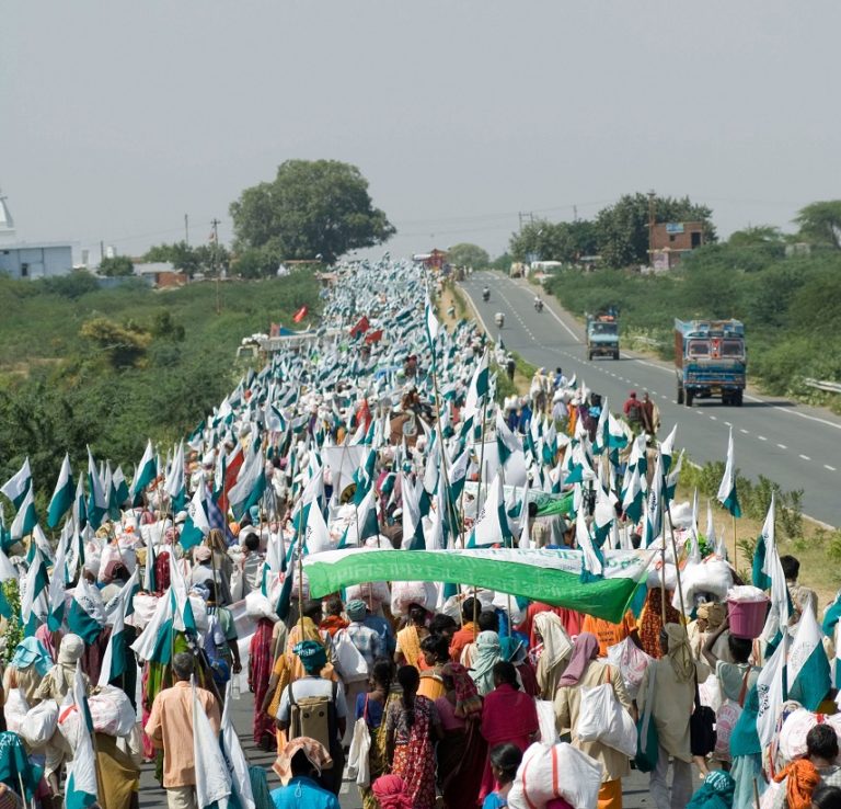 บรรยากาศการเดินขบวนจานาเดจ 2007 ที่มาภาพ: http://upload.wikimedia.org/wikipedia/commons/a/a9/Janadesh_2007%2C_walking_to_Delhi.jpg